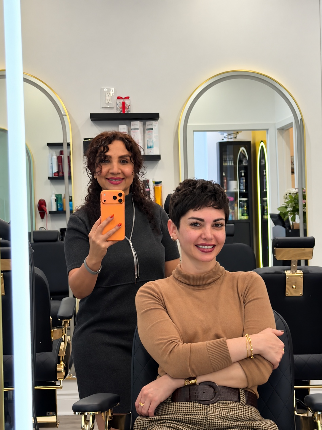 Marjan Momeni standing beside a client in the salon